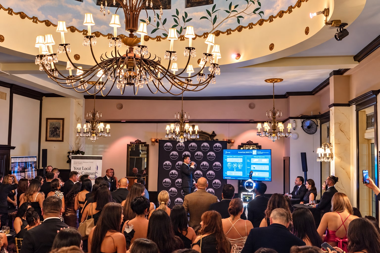 Guests gathered beneath the chandeliers in the historic ballroom